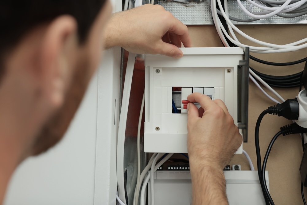 Electrician fixing a circuit breaker